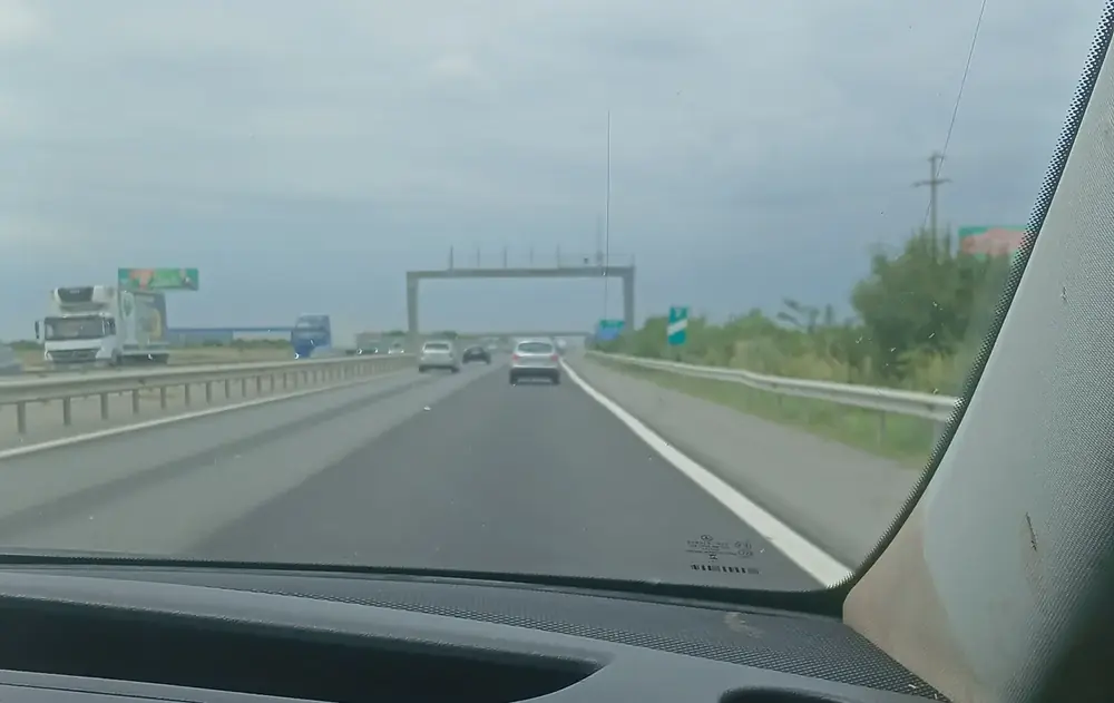 The road from Otopeni, seen from the front of a minivan — dual carriageway, light traffic, flat country the whole way