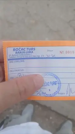 The ticket, written out by hand at the office counter — destination, date and the stamp