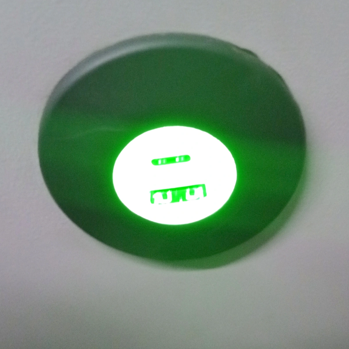 A USB charging socket, lit green — one USB-A and one USB-C