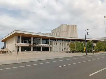 Marin Sorescu National Theatre in Craiova — travertine modernist building with a wide flat roof and plaza
