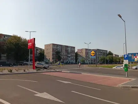The Penny and Lidl totems on Bulevardul Dacia in Craiova seen from the shared car park, apartment blocks behind