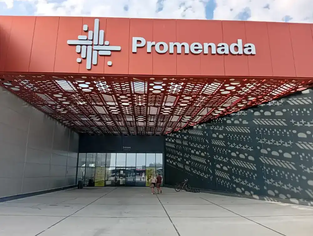 The main entrance under the perforated red canopy