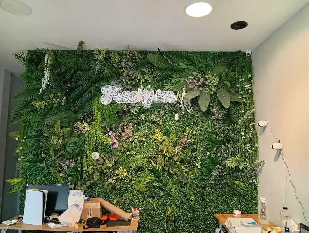 The green wall and neon behind the service desks
