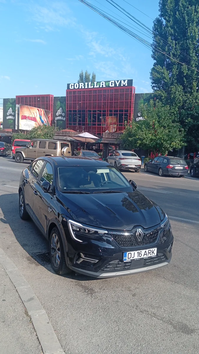 Gorilla Gym on its main road — red steel frame, glass box, terrace café underneath
