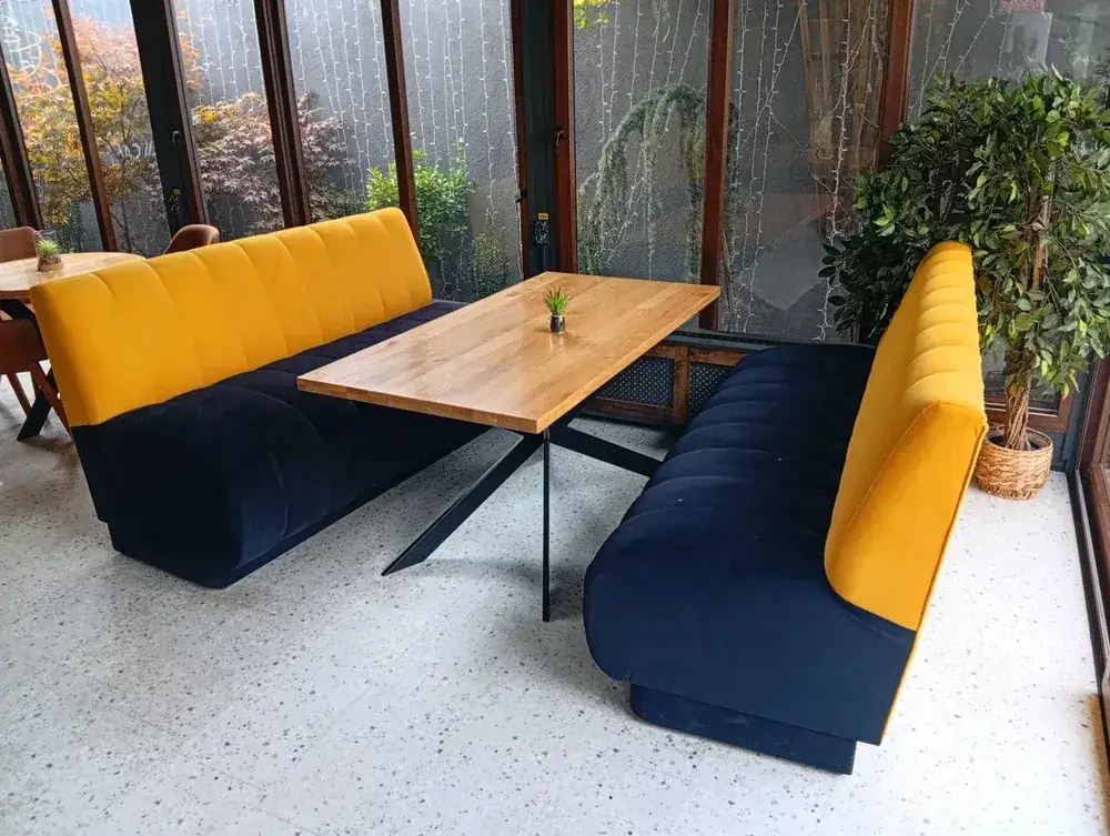 Tables along the banquette, mural at the far end