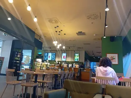 The Starbucks room inside Mercur Center in Craiova, tables and the bar at the back