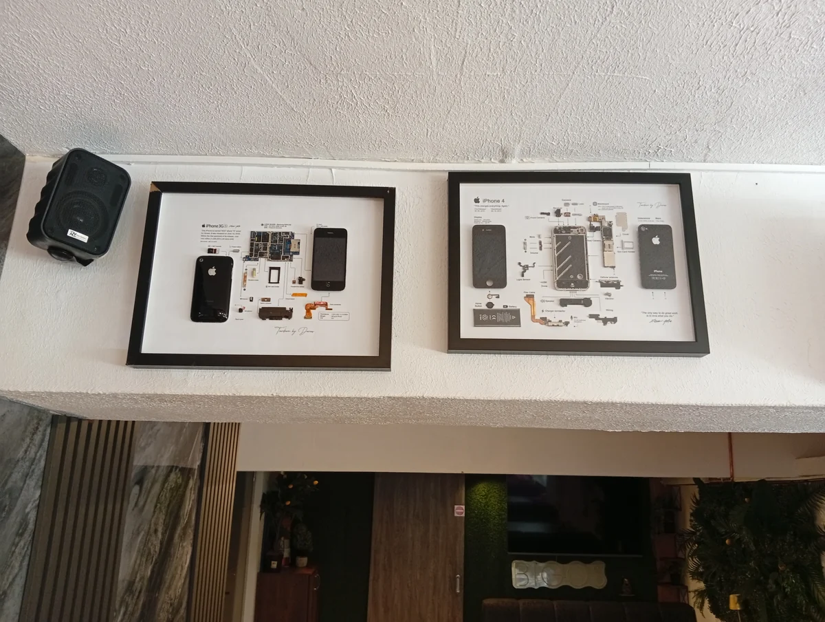 Framed iPhone teardowns on the wall