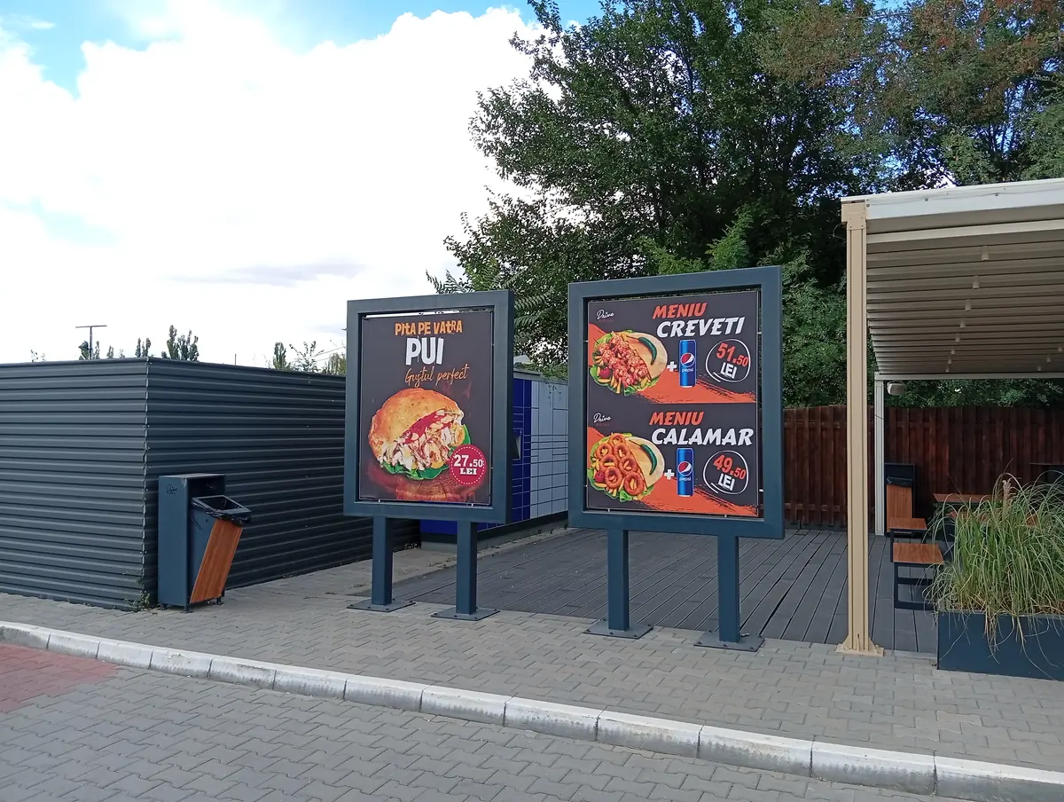 Posters at Drive Grill, Craiova: hearth-baked chicken pita at 27.50 lei, shrimp menu at 51.50 lei and calamari menu at 49.50 lei, 22 September 2026