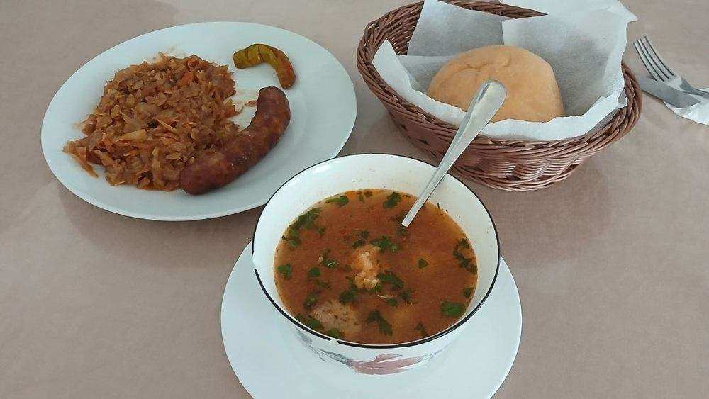 Ciorbă, sausage with stewed cabbage and bread still warm
