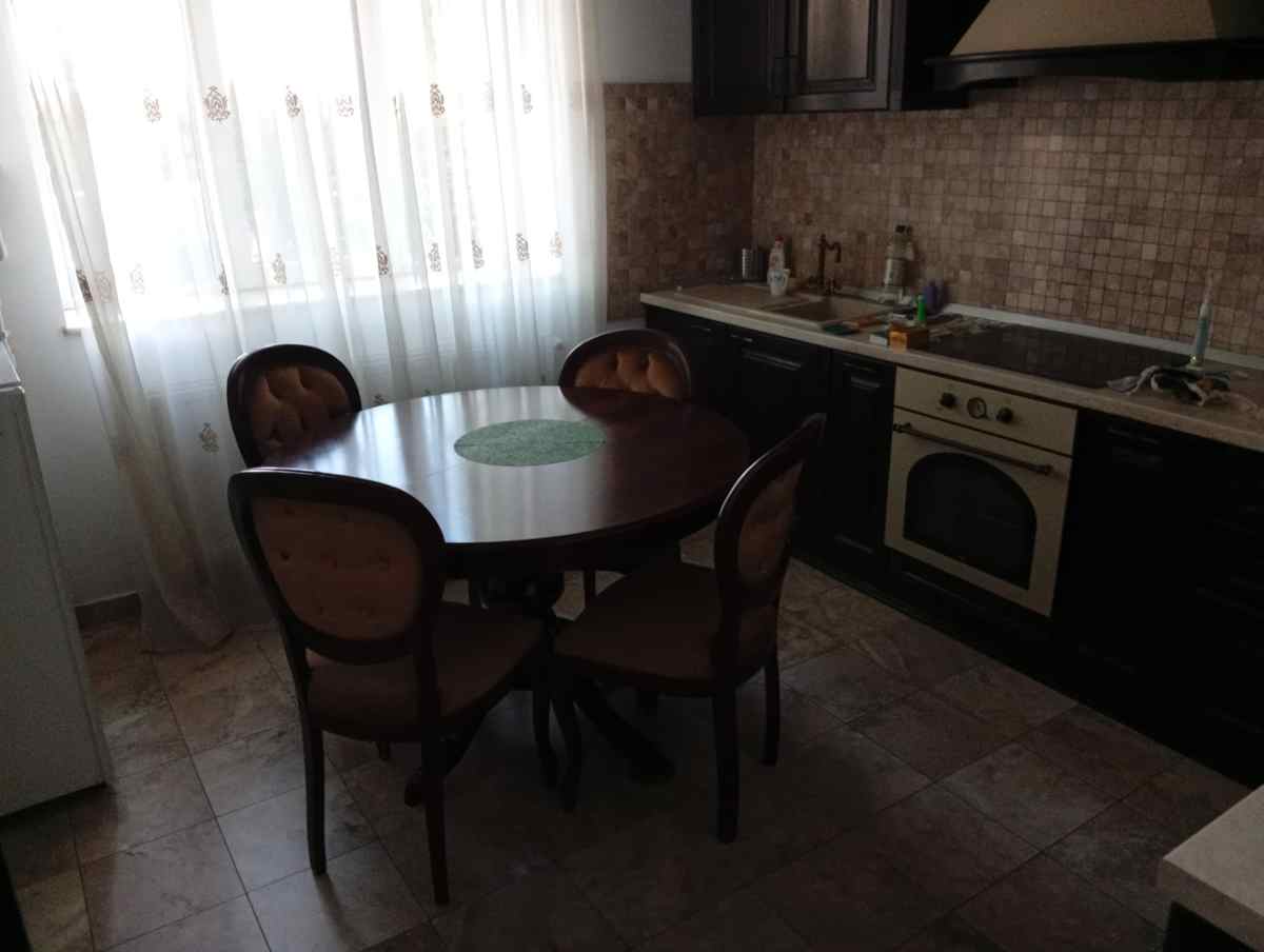 Kitchen — oven, hob, fridge, table for four